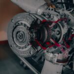 a close up of a jet engine with red paint on it