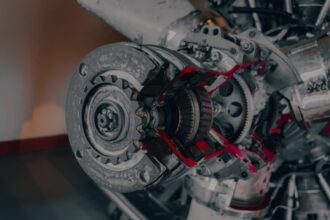 a close up of a jet engine with red paint on it