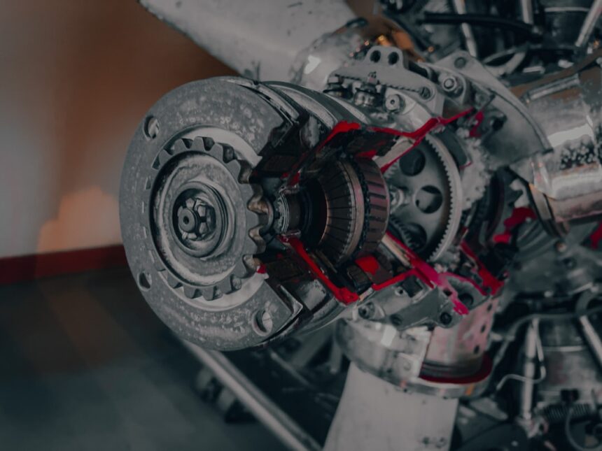 a close up of a jet engine with red paint on it