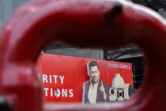 Man featured on a red advertisement board.