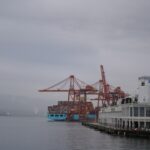 Cargo ship and cranes at a busy port