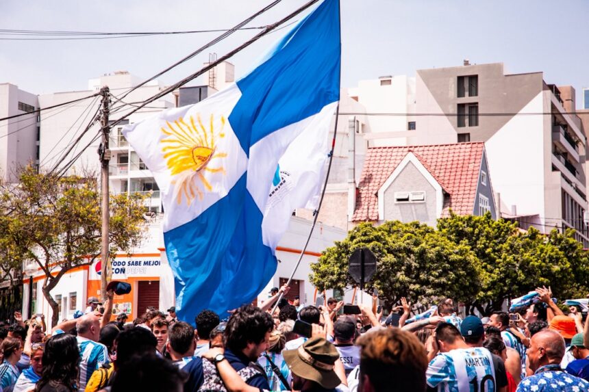 a crowd of people standing around a flag