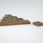 a scrabble of letters spelling a pyramid of words