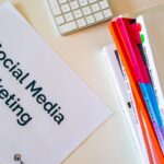 a sign that says social media marketing next to a keyboard