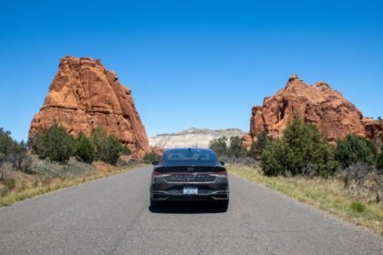 A car driving down a road in the desert