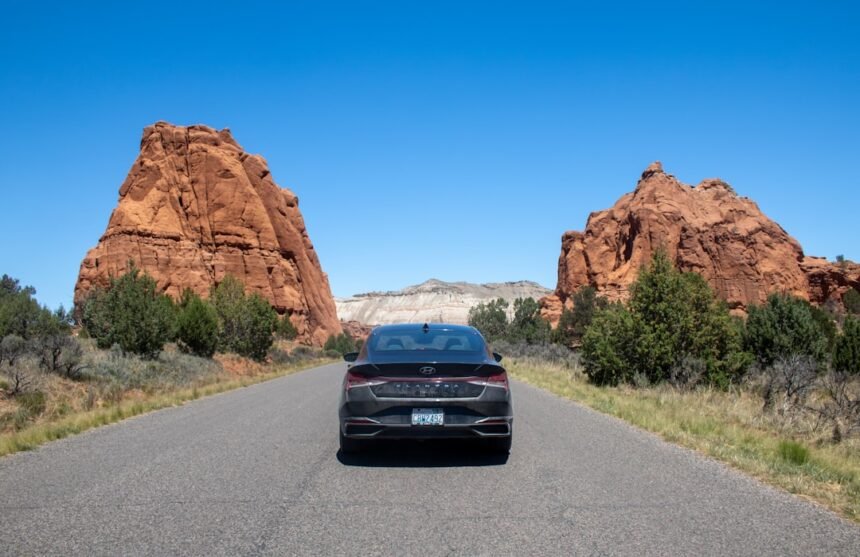 A car driving down a road in the desert