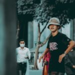 man in black crew neck t-shirt and red pants walking on street during daytime