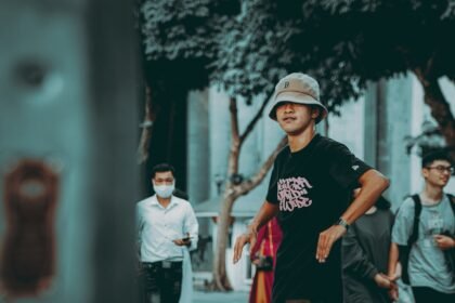 man in black crew neck t-shirt and red pants walking on street during daytime