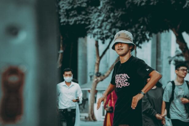 man in black crew neck t-shirt and red pants walking on street during daytime