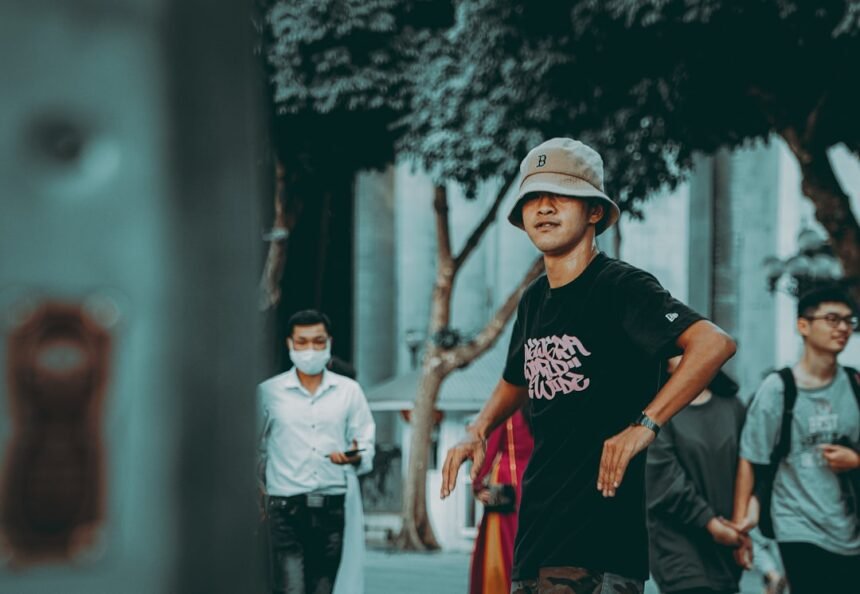 man in black crew neck t-shirt and red pants walking on street during daytime