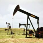 a group of oil pumps sitting on top of a field