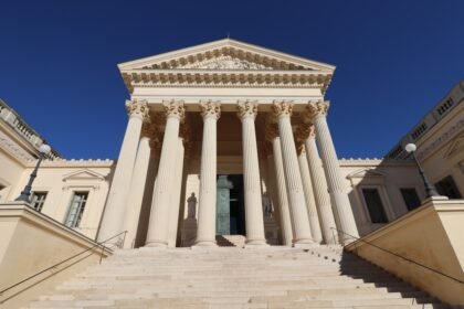 a large building with columns and a door