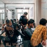 a group of people sitting at computers