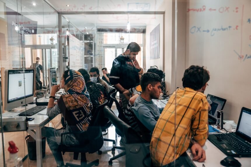 a group of people sitting at computers
