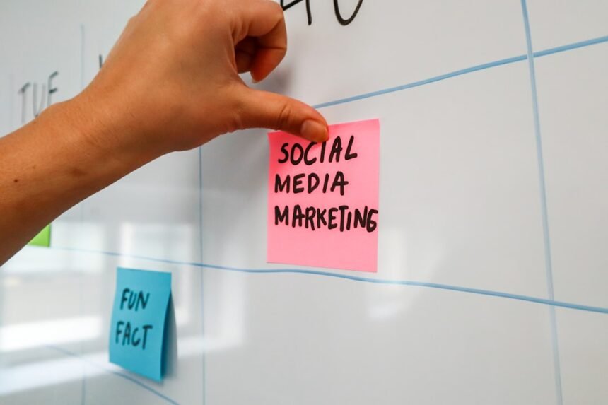 a hand is writing on a sticky note
