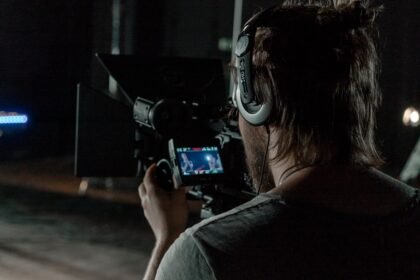 man in gray shirt holding camera