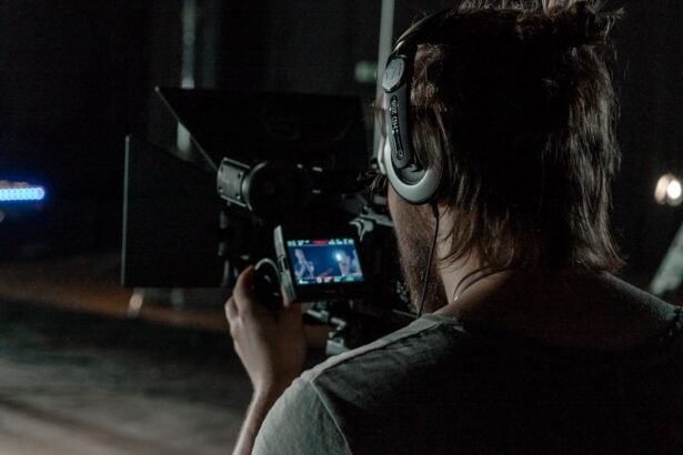 man in gray shirt holding camera