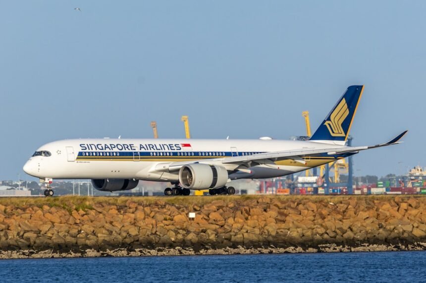 Singapore airlines airplane on tarmac with blue sky background