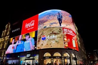 Brightly lit billboards on a building at night