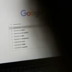 black laptop computer turned on displaying google search