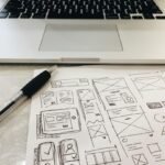 black pen on table beside grey laptop computer