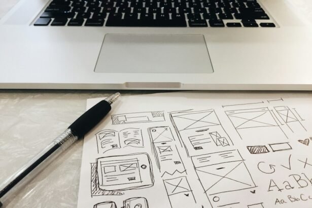 black pen on table beside grey laptop computer